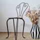 Small chair / stool in twisted wrought iron and floral ceramic.