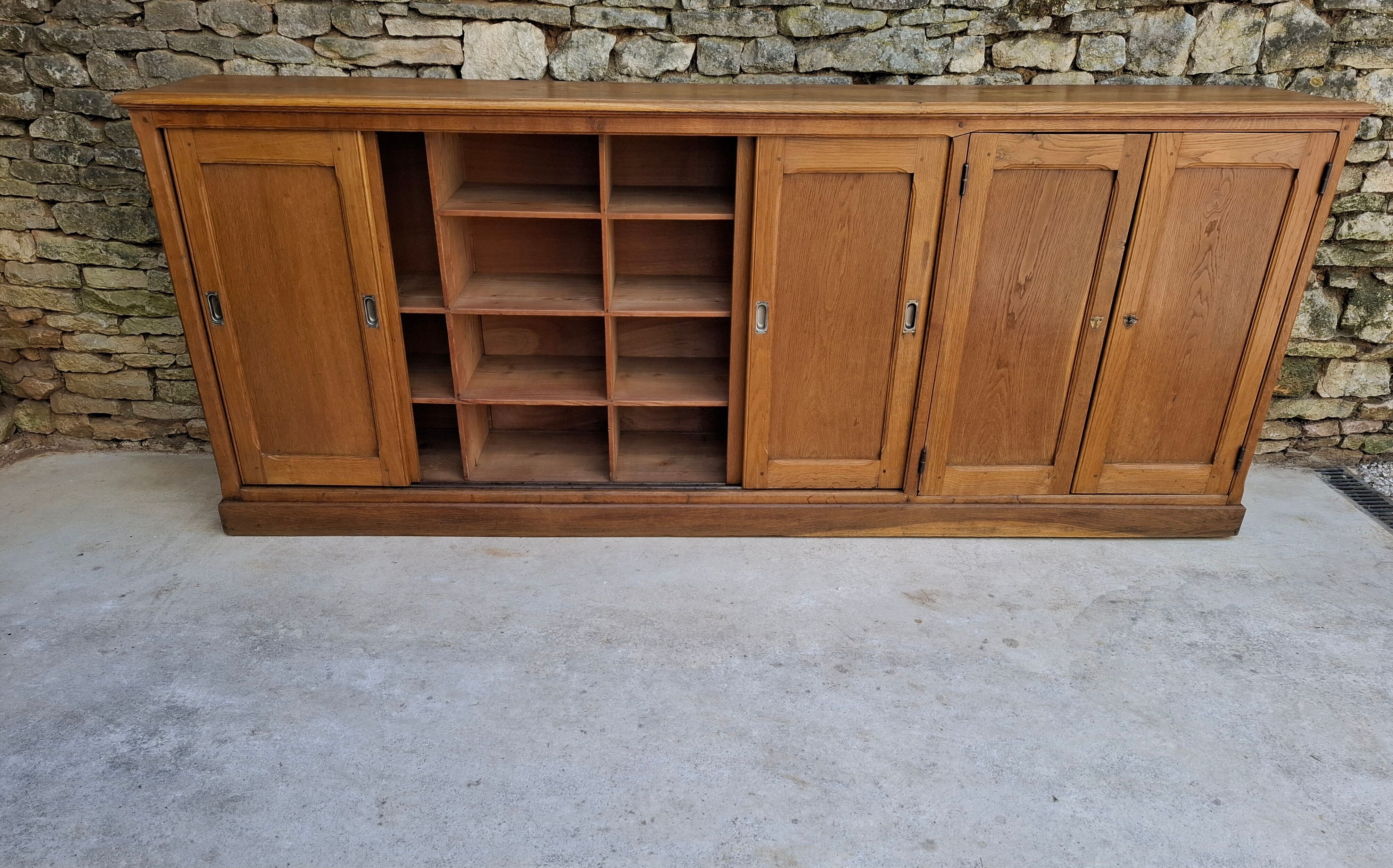 Oak workshop furniture with sliding doors.