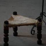 Vintage African artisanal stool, triangular shape with 3 legs, cowhide, 20th century.