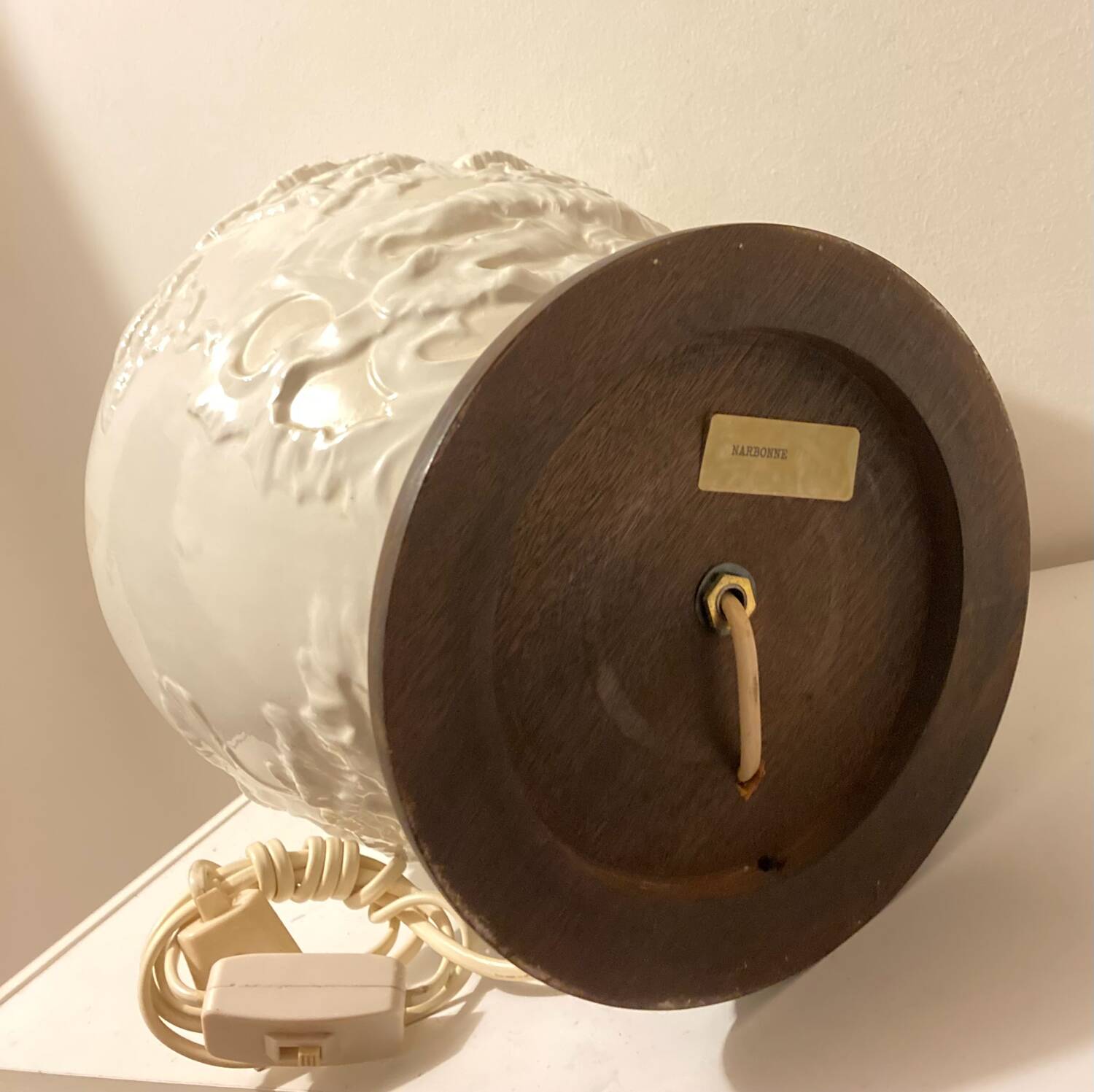 1980s ceramic table lamp with a wooden base and adjustable shade.