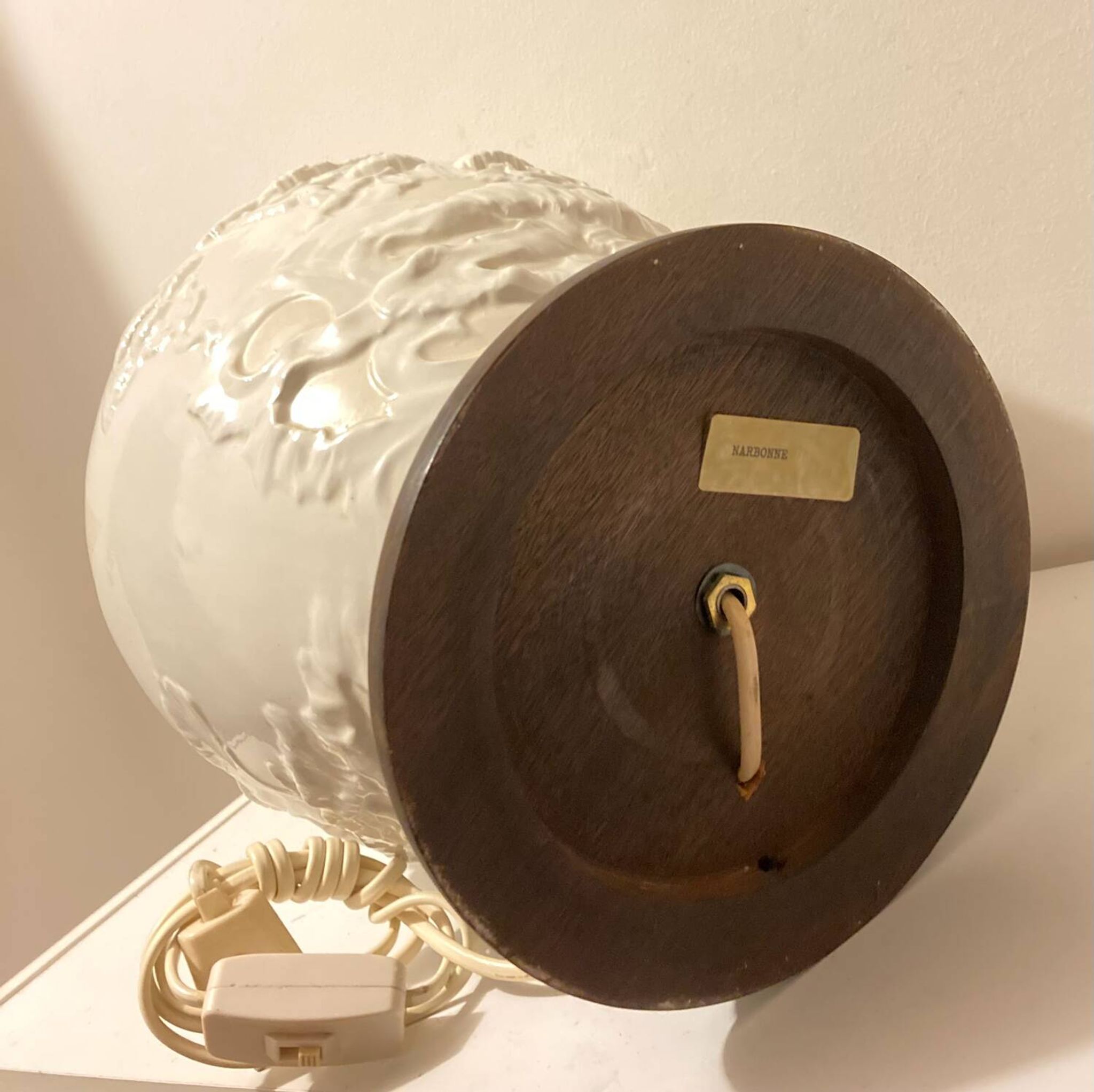1980s ceramic table lamp with a wooden base and adjustable shade.