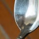 15 small silver metal spoons with rows of beads