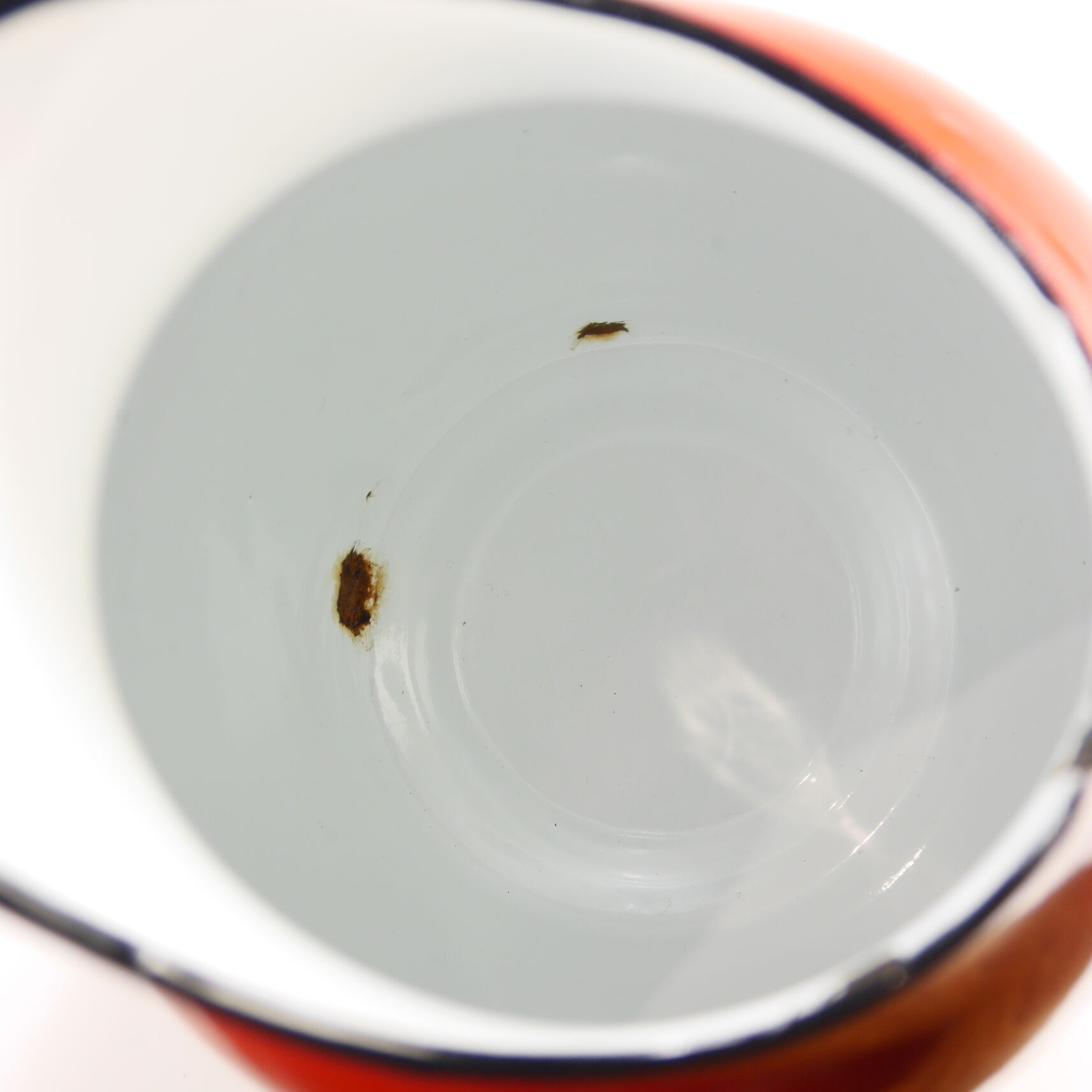 Red enameled metal pitcher