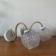 Large pair of brass swan neck wall lights with transparent glass globes.