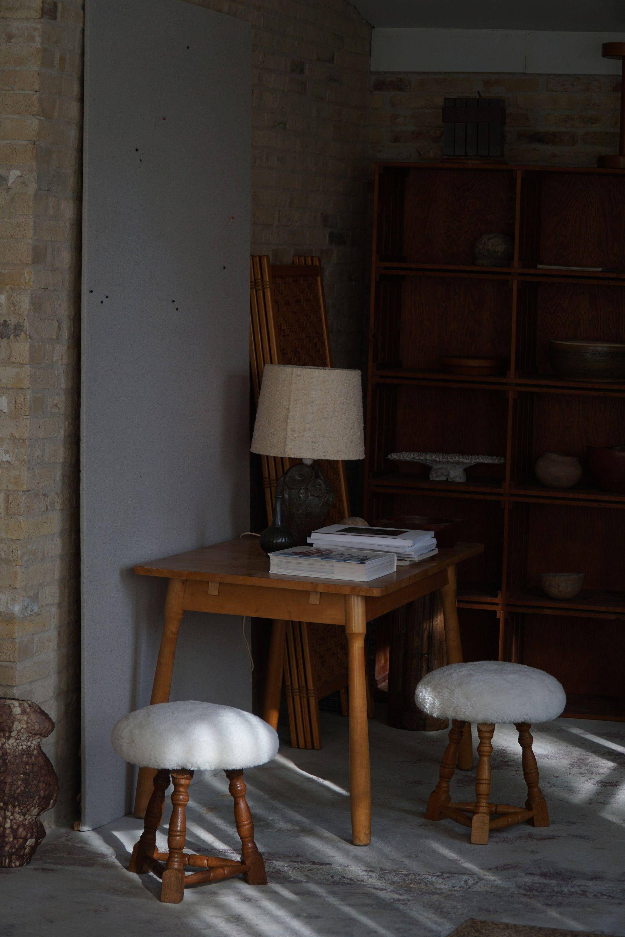 Modern Danish, a pair of tripod stools, seats reupholstered in lambswool, 1950s.