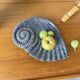 Shell-shaped ceramic catchall.