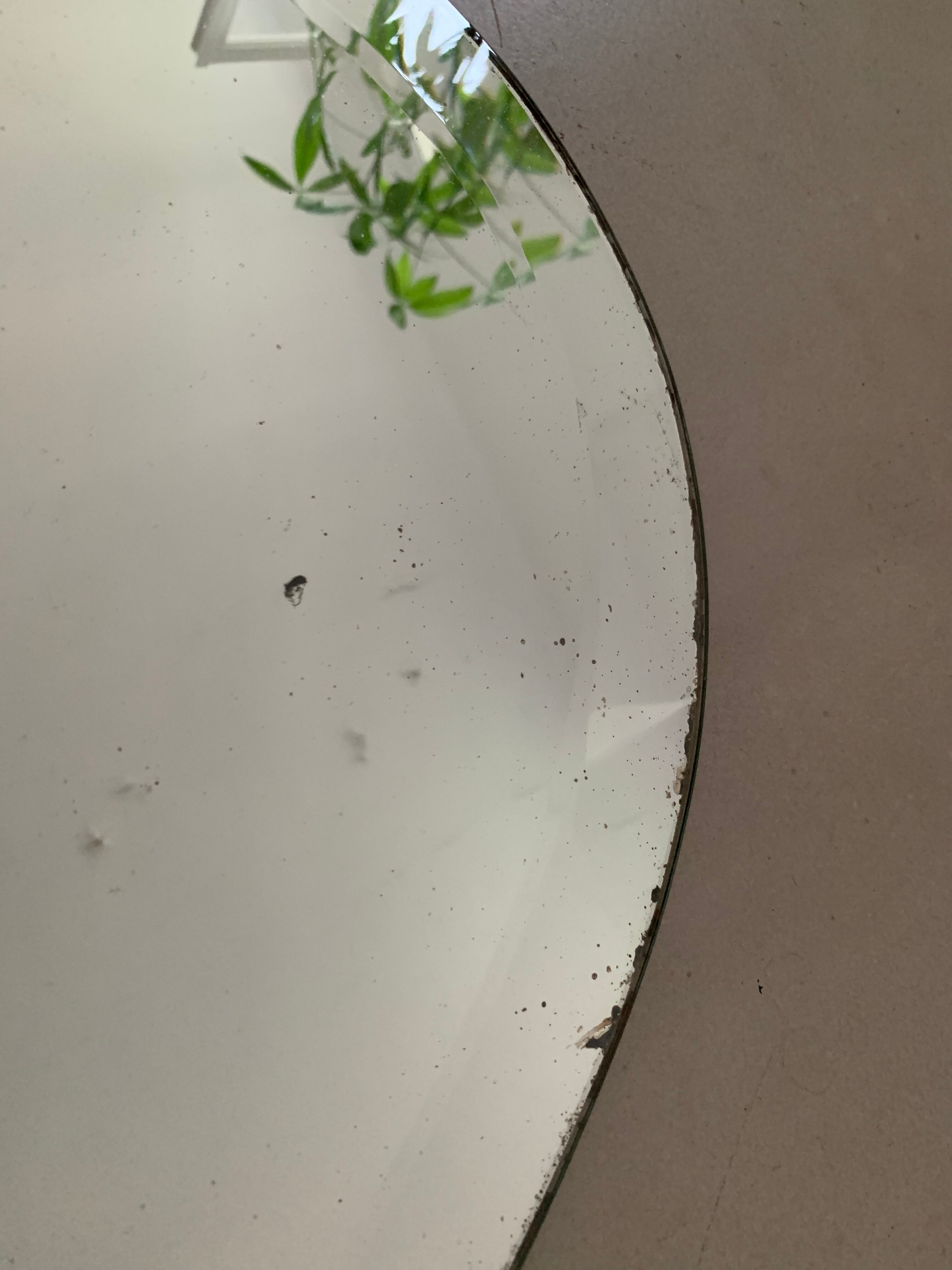 Old bevelled stitched oval mirror