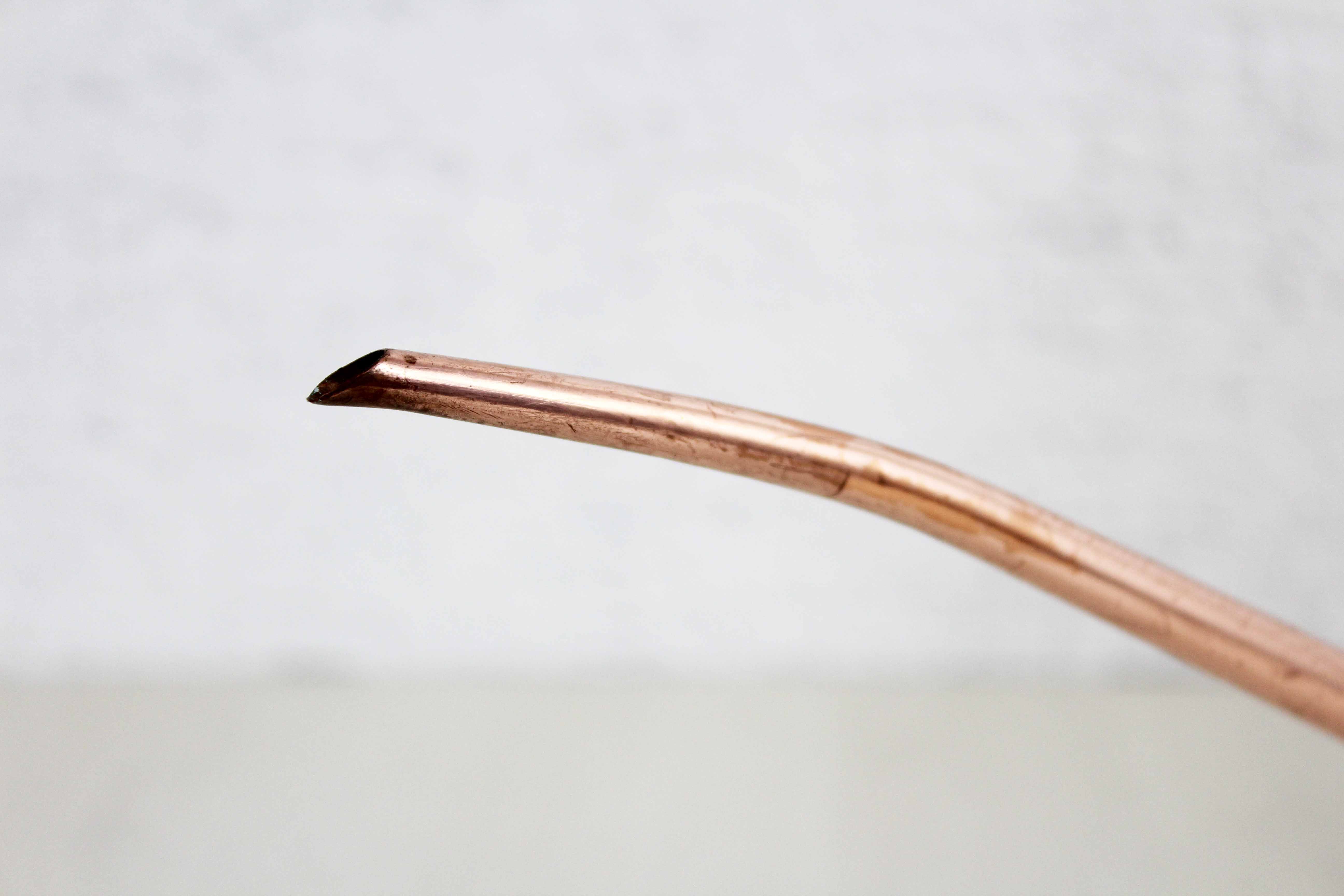 Watering can in brass and copper