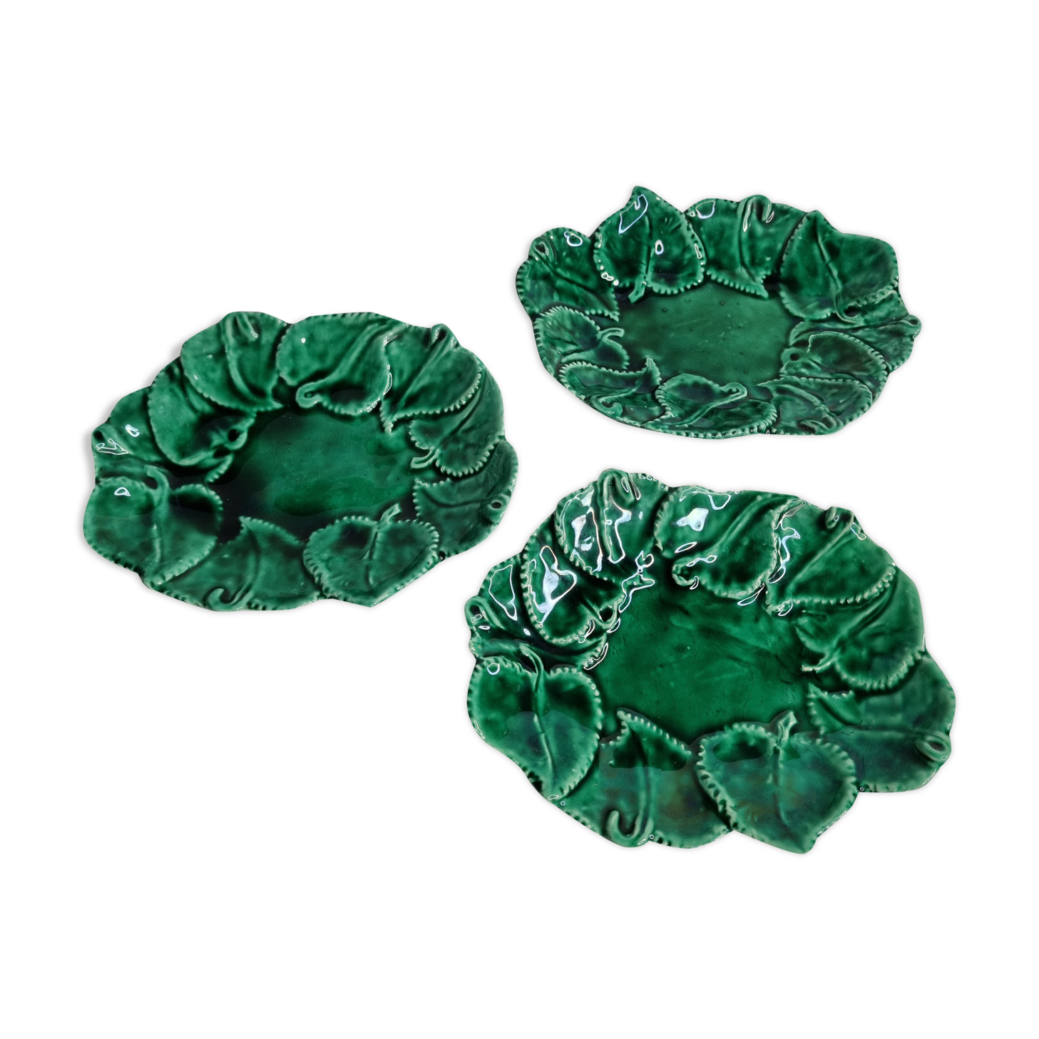 Set of three enamelled, emerald green, leaf-decorated faent cups