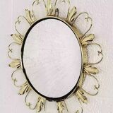 Round mirror on brass frame with scrolls