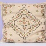 Vintage beige embroidered cushion green motif