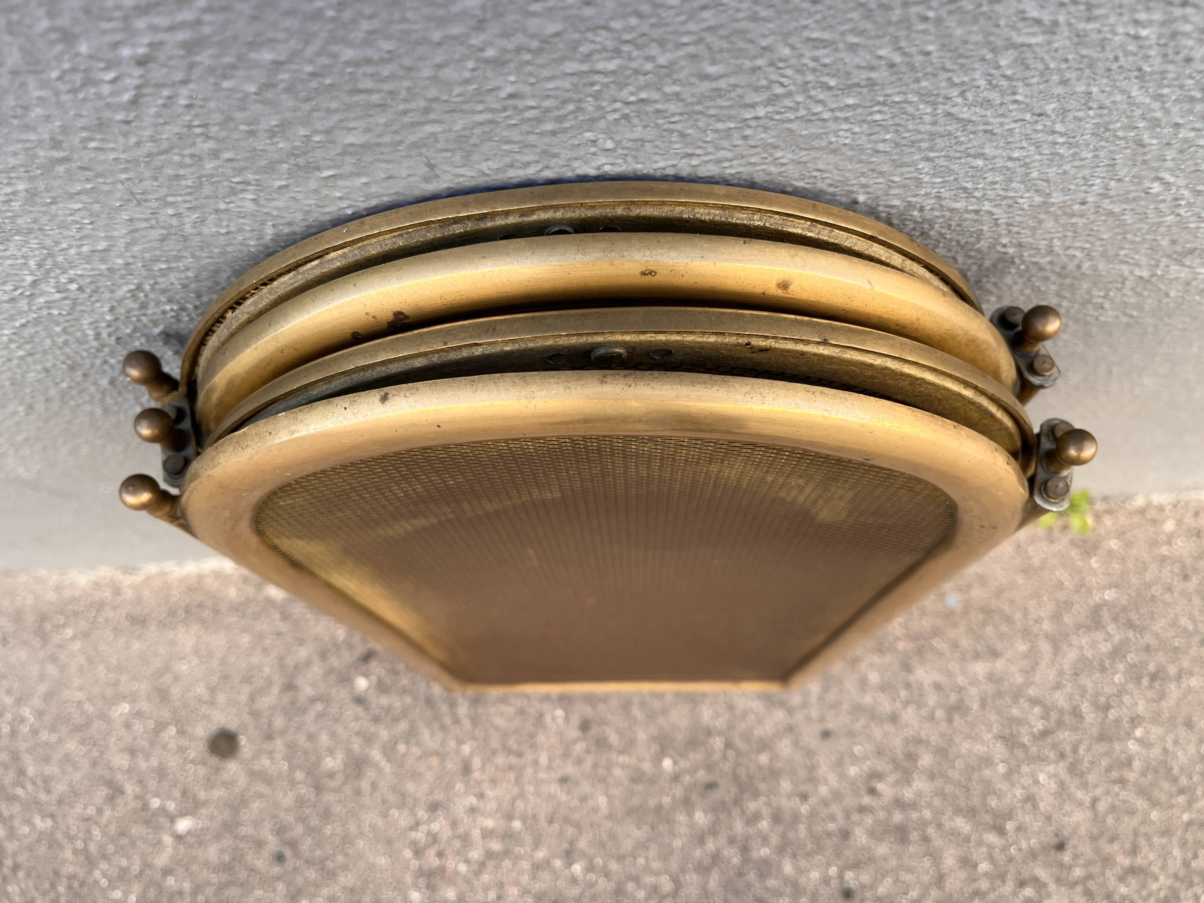 Antique brass fireplace screen from 1920, vintage spark guard.