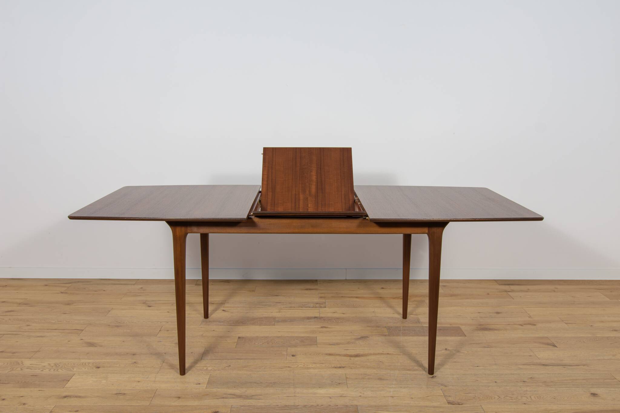 Extendable teak dining table in Mid-Century style from McIntosh, UK.
