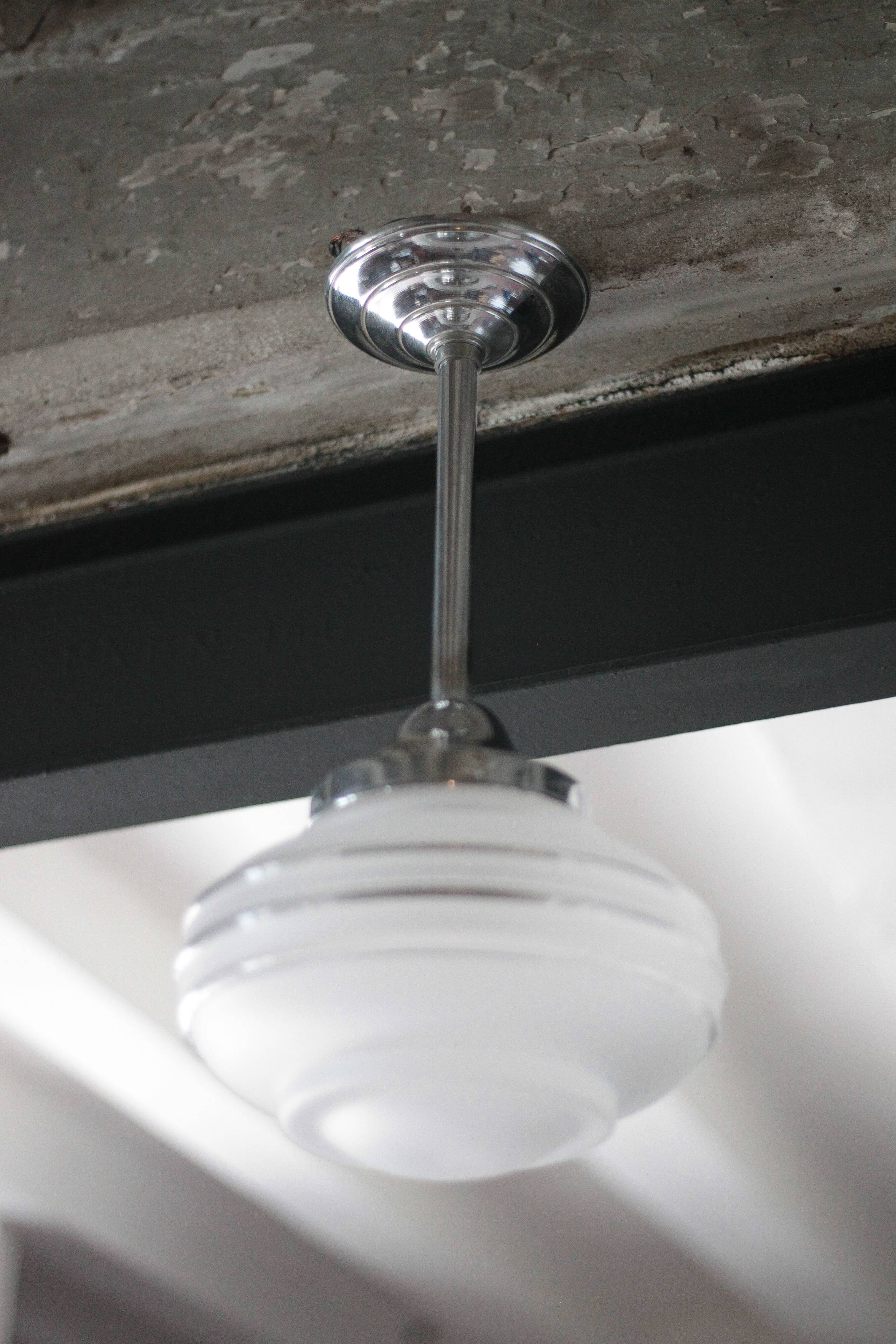 Art Deco pendant light, chrome metal suspension and glass globe, ceiling lamp.