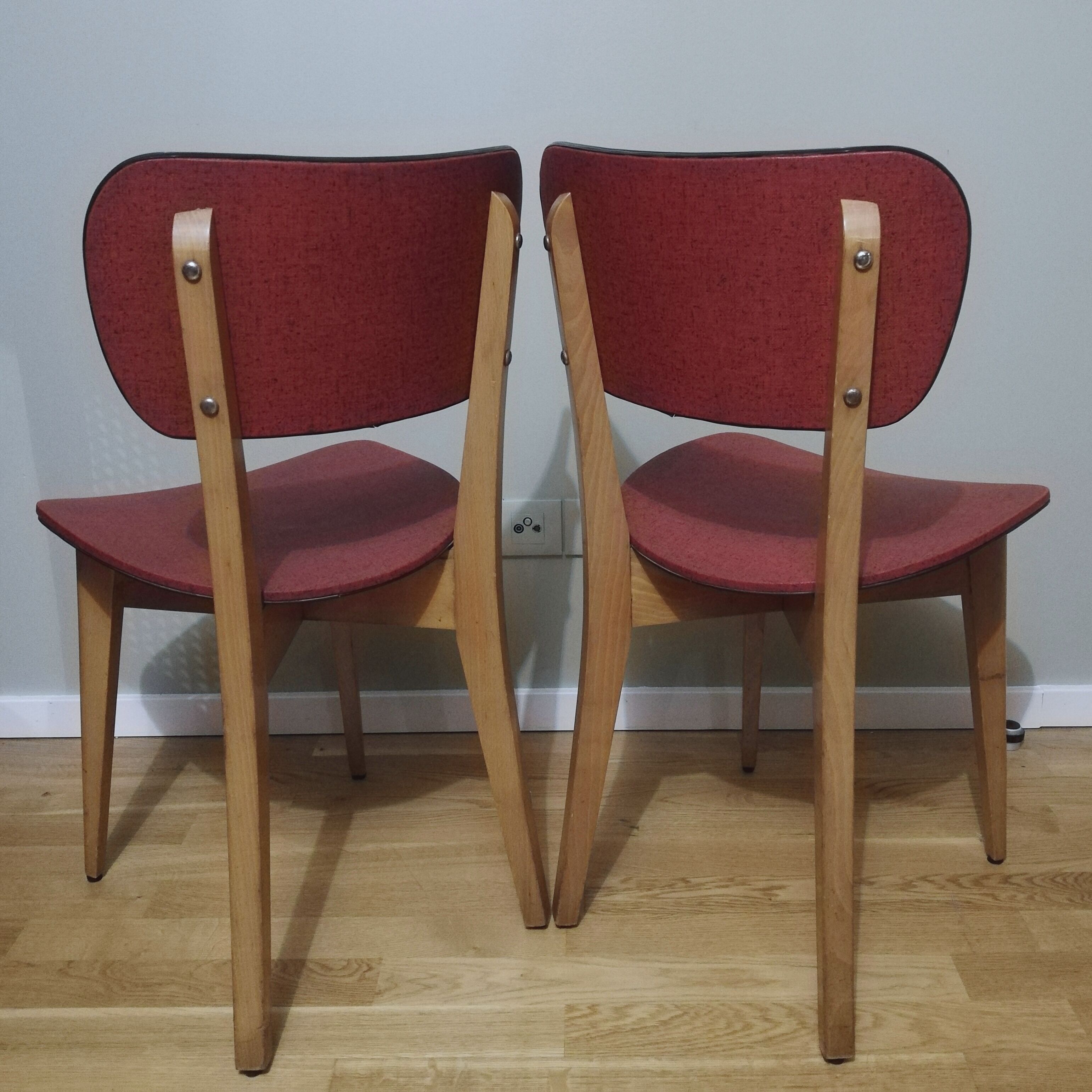Two vintage chairs wood and mottled red vinyl