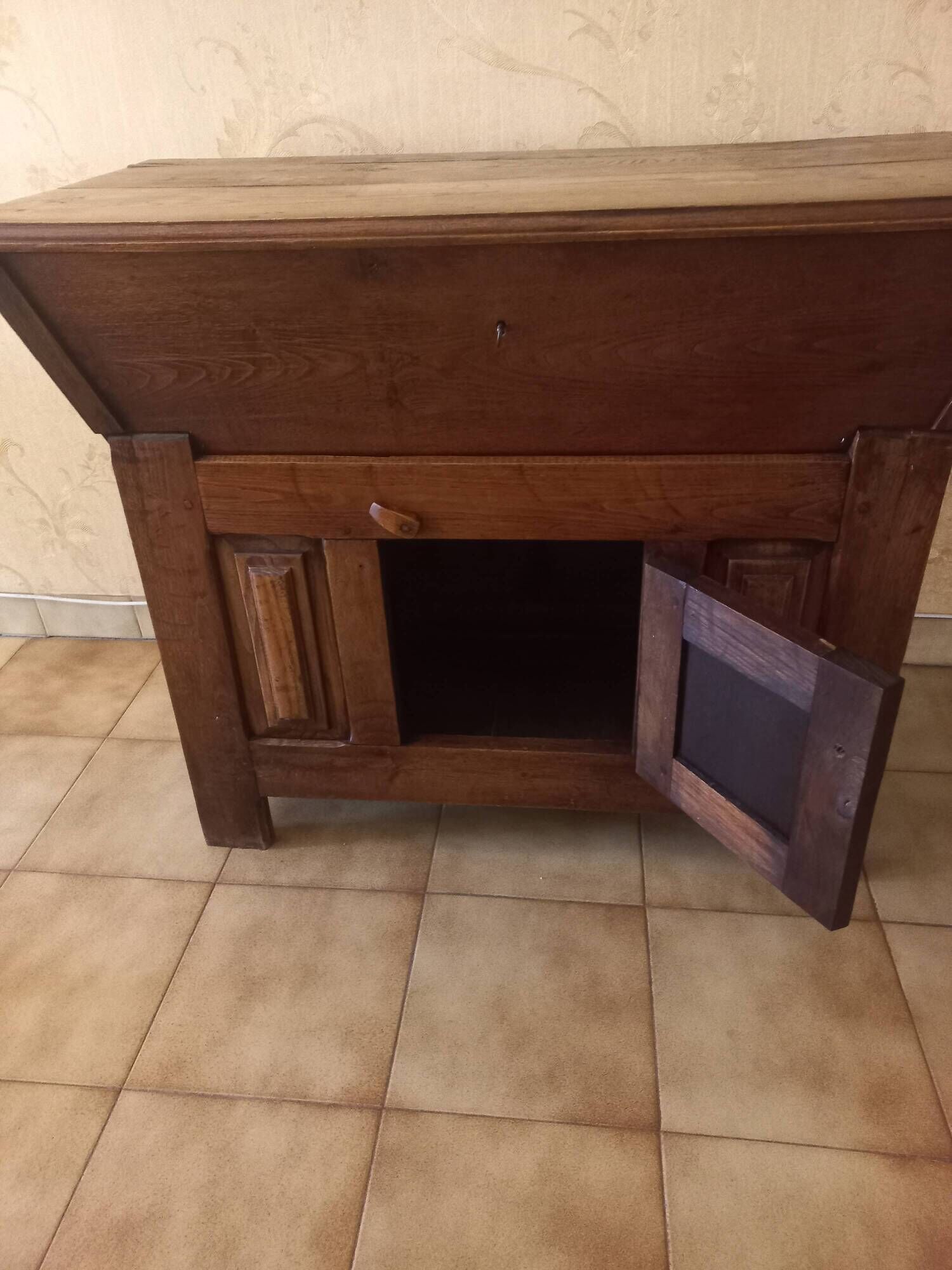 Old solid wood dough mixer carefully transformed into a bar cabinet.