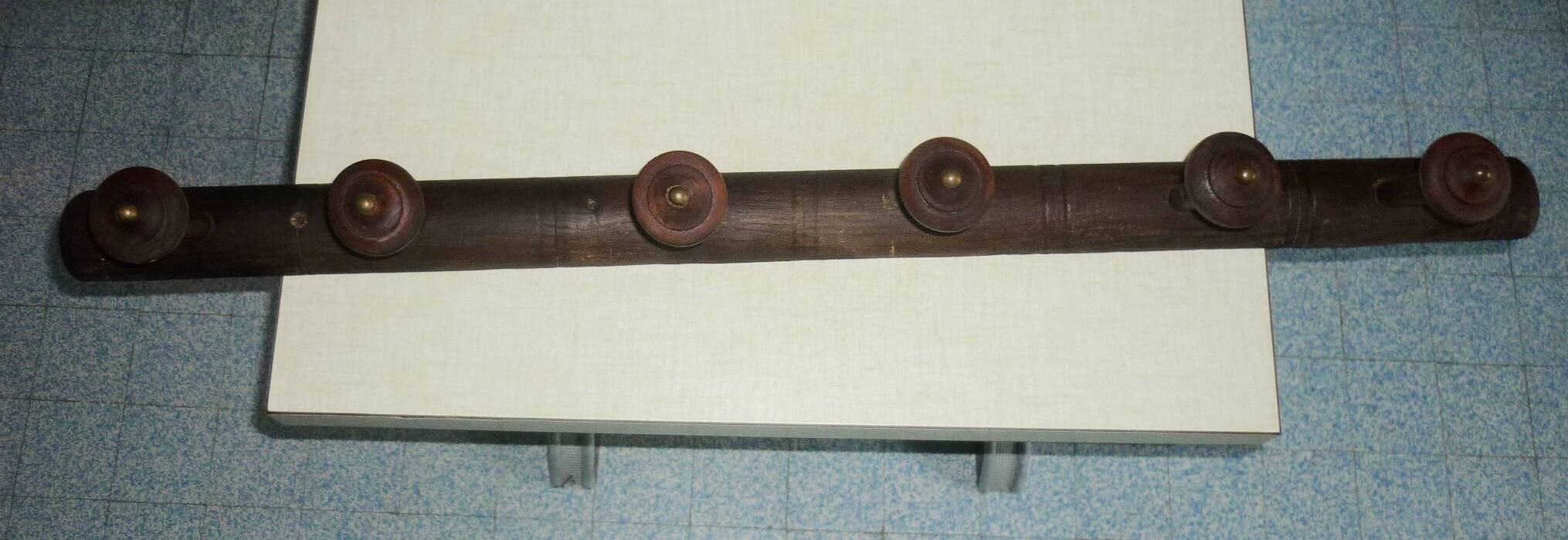 Wooden wall-mounted coat rack