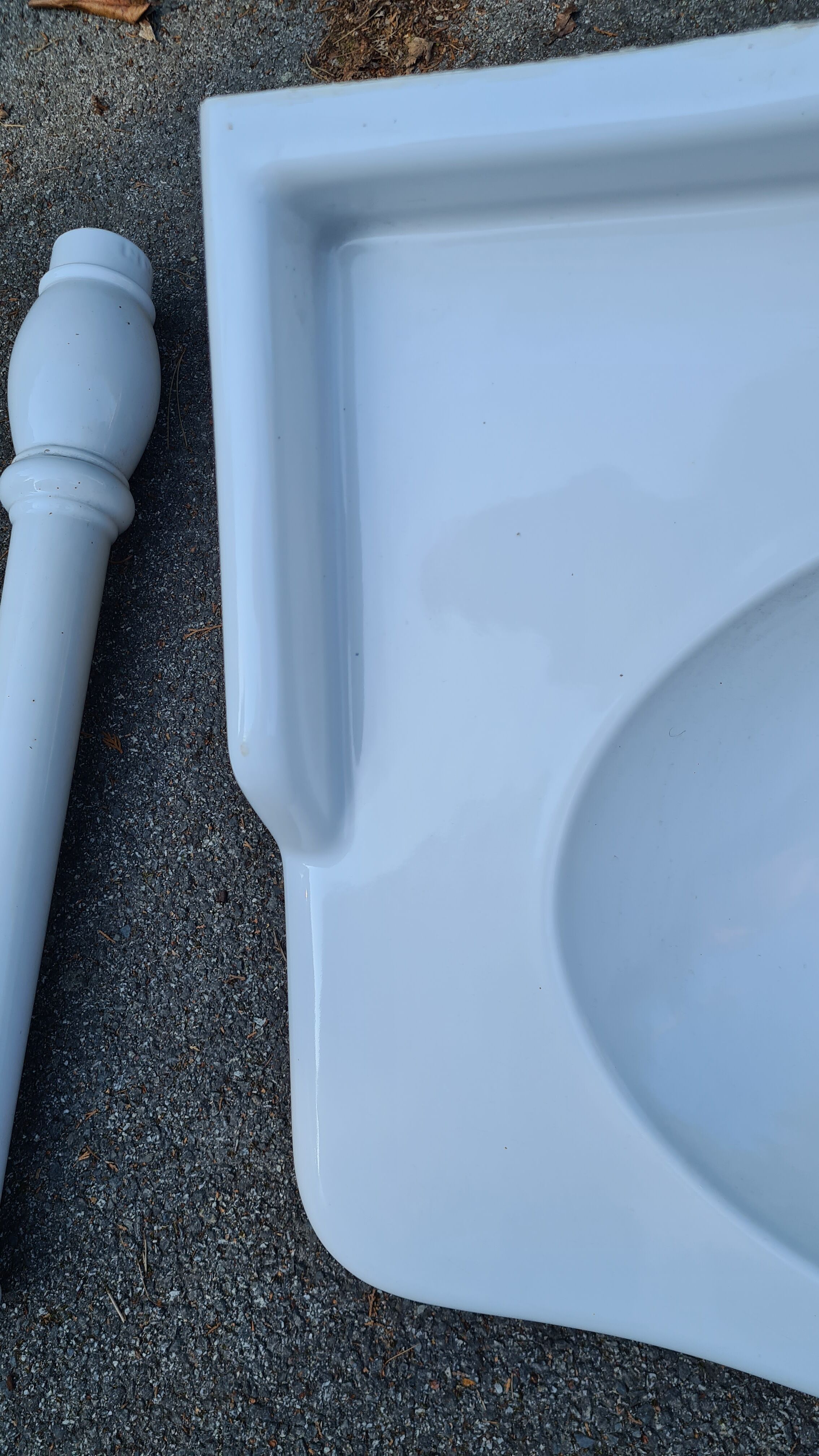 White ceramic wall washbasin with 2 ceramic legs
