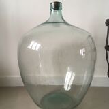 Old demijohn and her metal basket