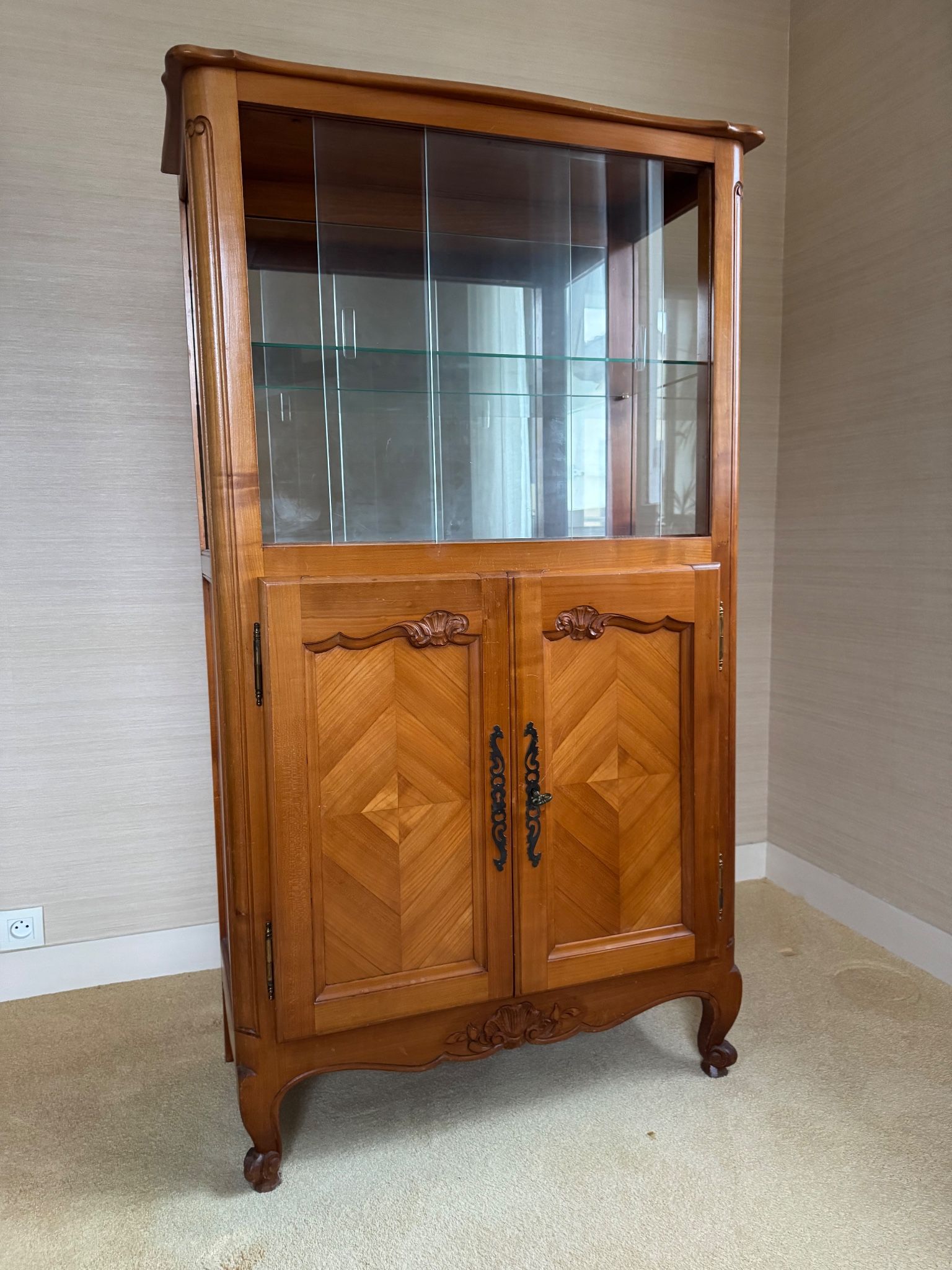 Louis XV style display cabinet, glass doors and chevron panels.