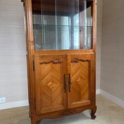 Louis XV style display cabinet, glass doors and chevron panels.