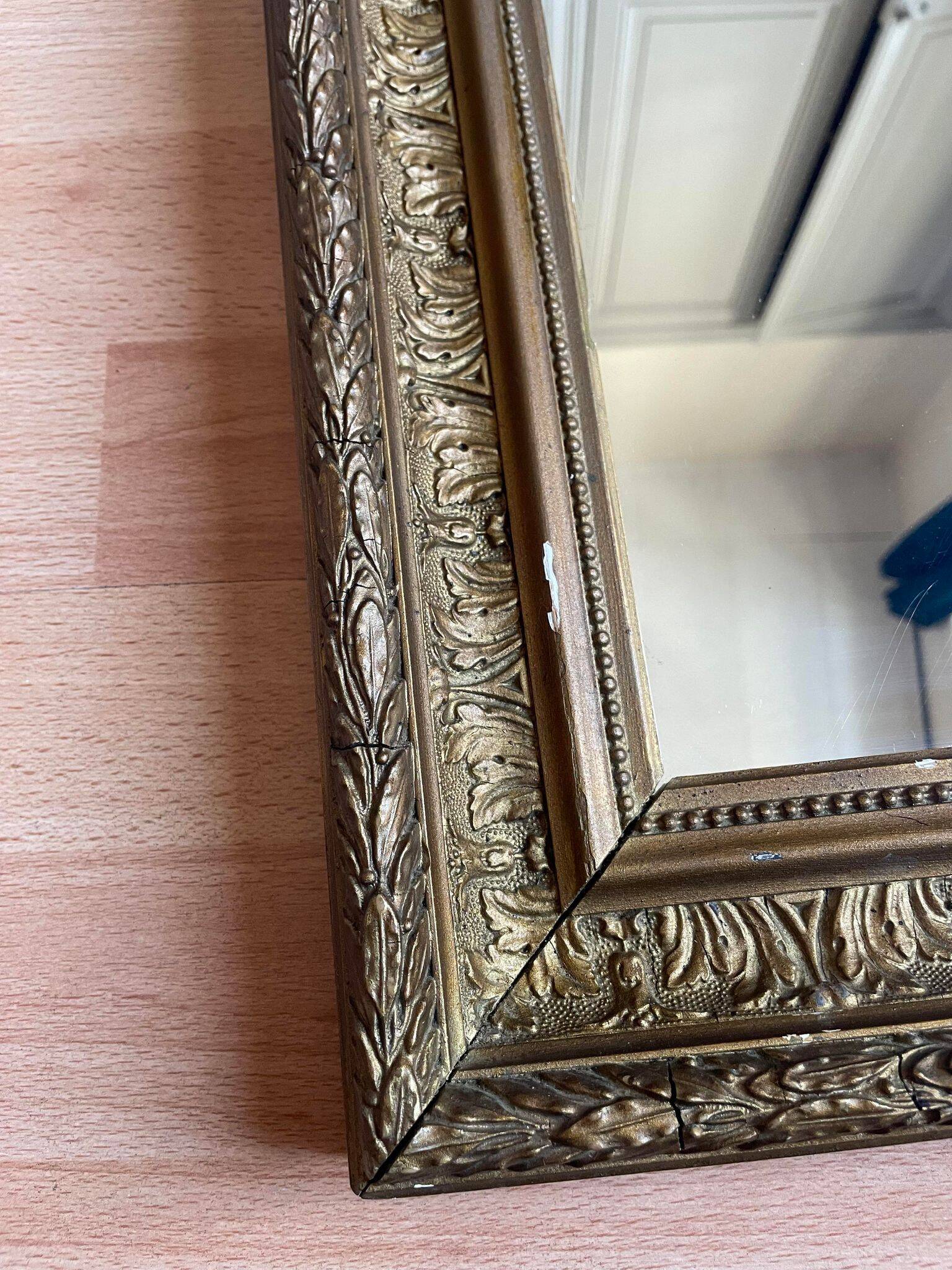 Old mirror with golden wooden frame