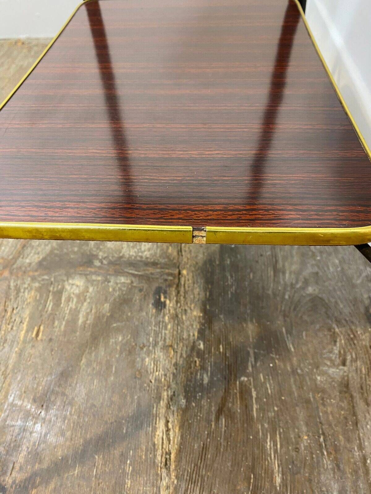 Vintage side table, brass gallery and wheels, 1950s.