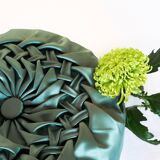 Round cushion in green pleated silk