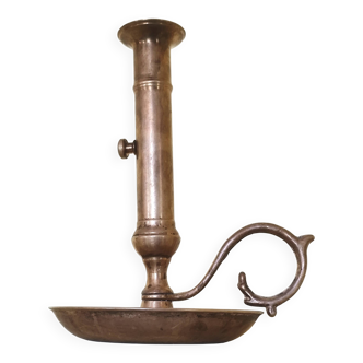 Brass and bronze hand candlestick on a round base and handle