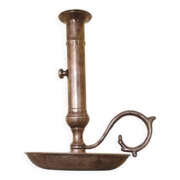 Brass and bronze hand candlestick on a round base and handle