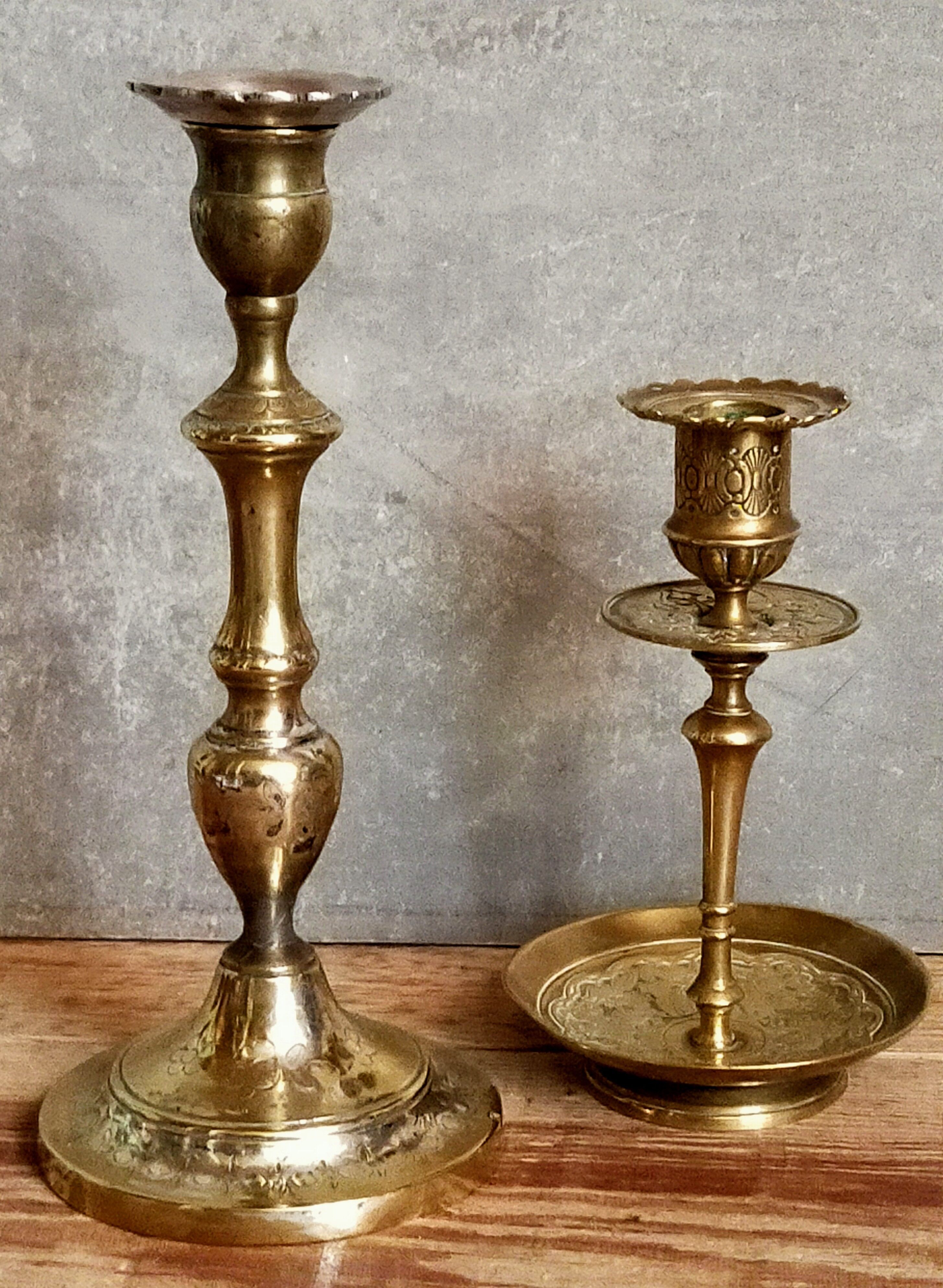 Duo of solid brass and gold metal candle holders worked old