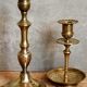 Duo of solid brass and gold metal candle holders worked old