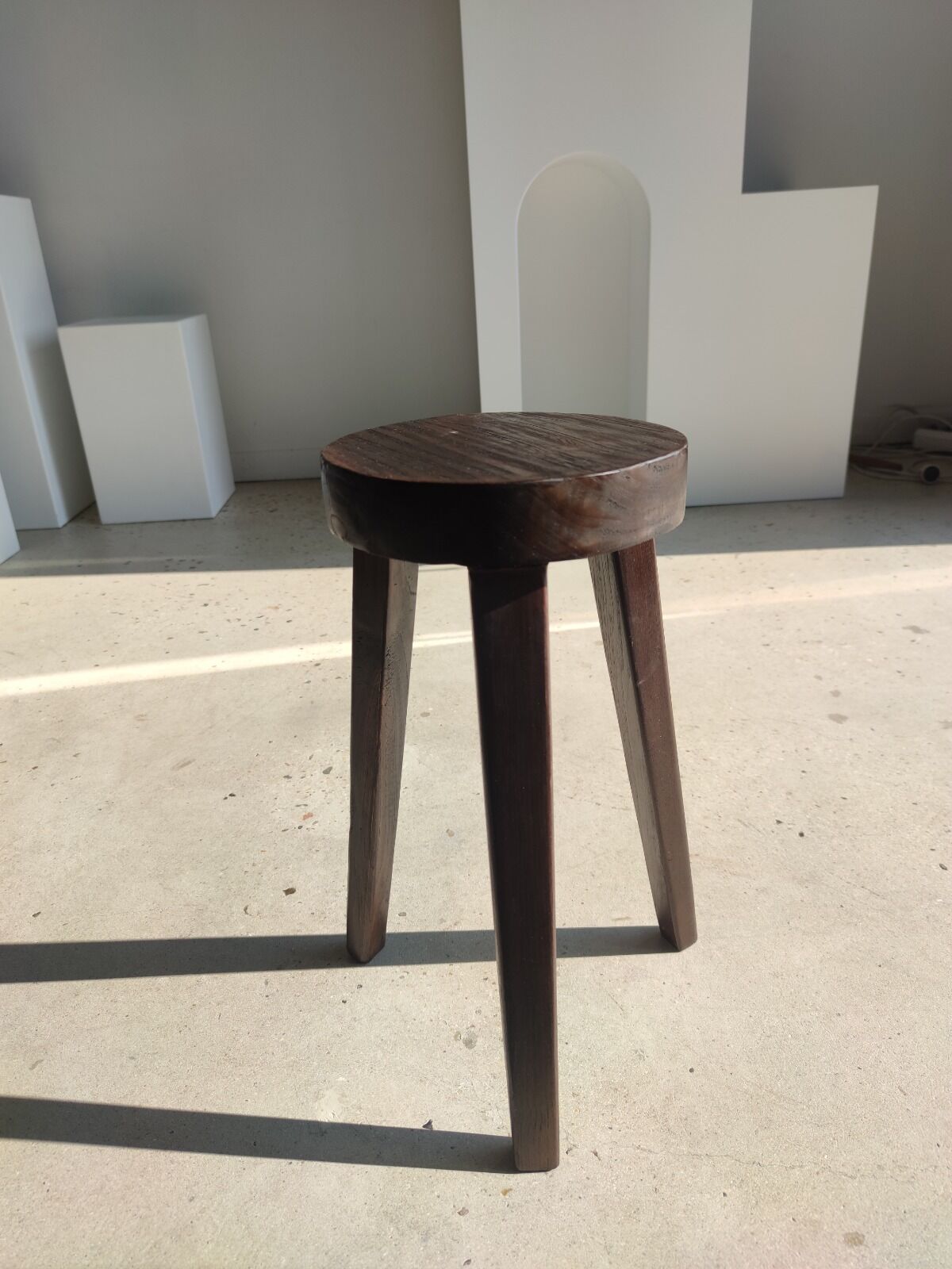 Small high tripod stool in brown solid wood