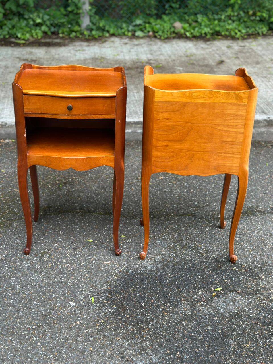 2 bedside tables in transitional or Louis XV style, made of curved solid wood with drawers.
