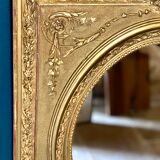 Mirror XIXth medallion on gilded frame with leaf