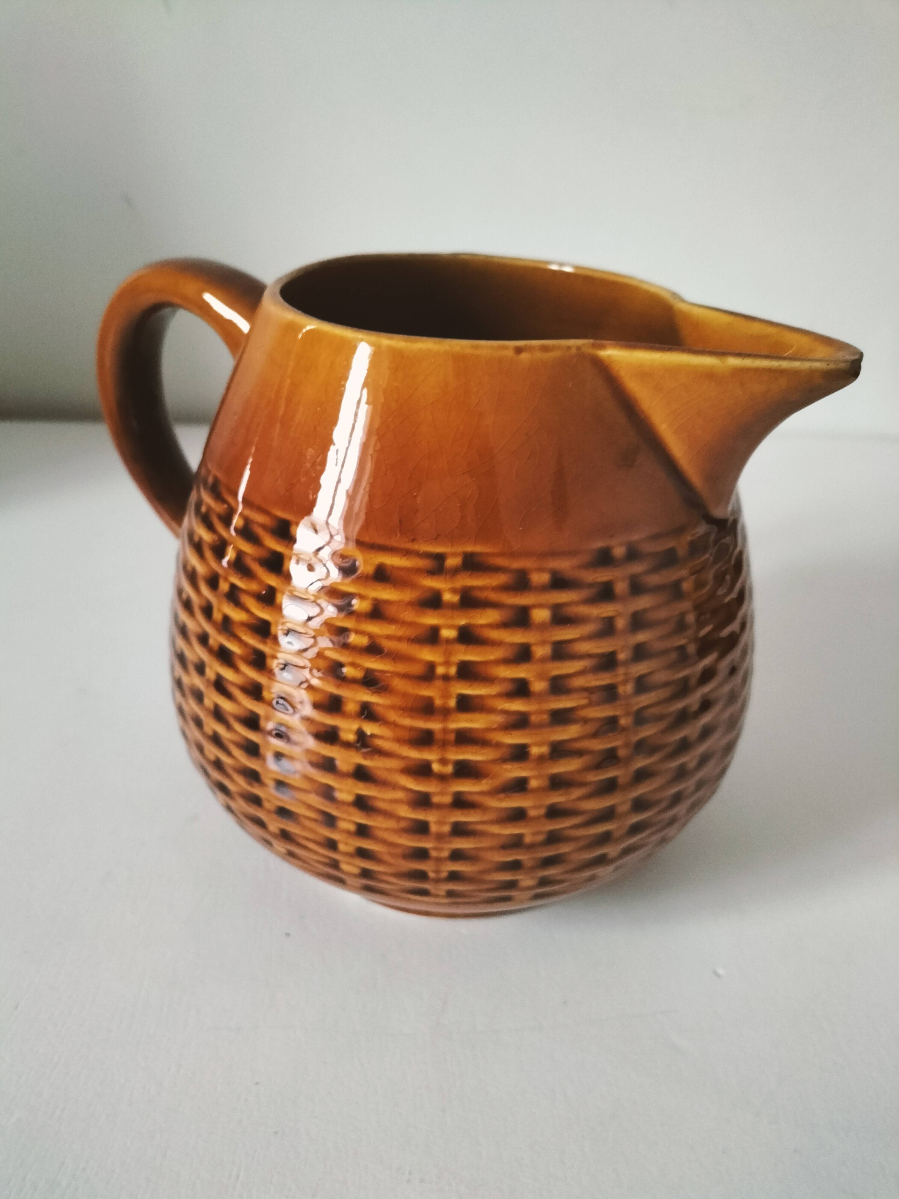 Caramel slipware pitcher with braided relief