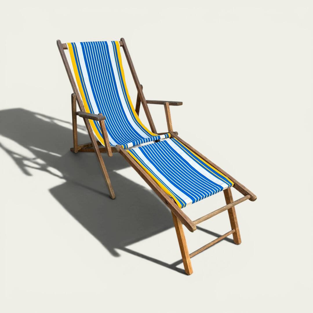 Vintage deck chair with blue and yellow striped fabric, original patina.