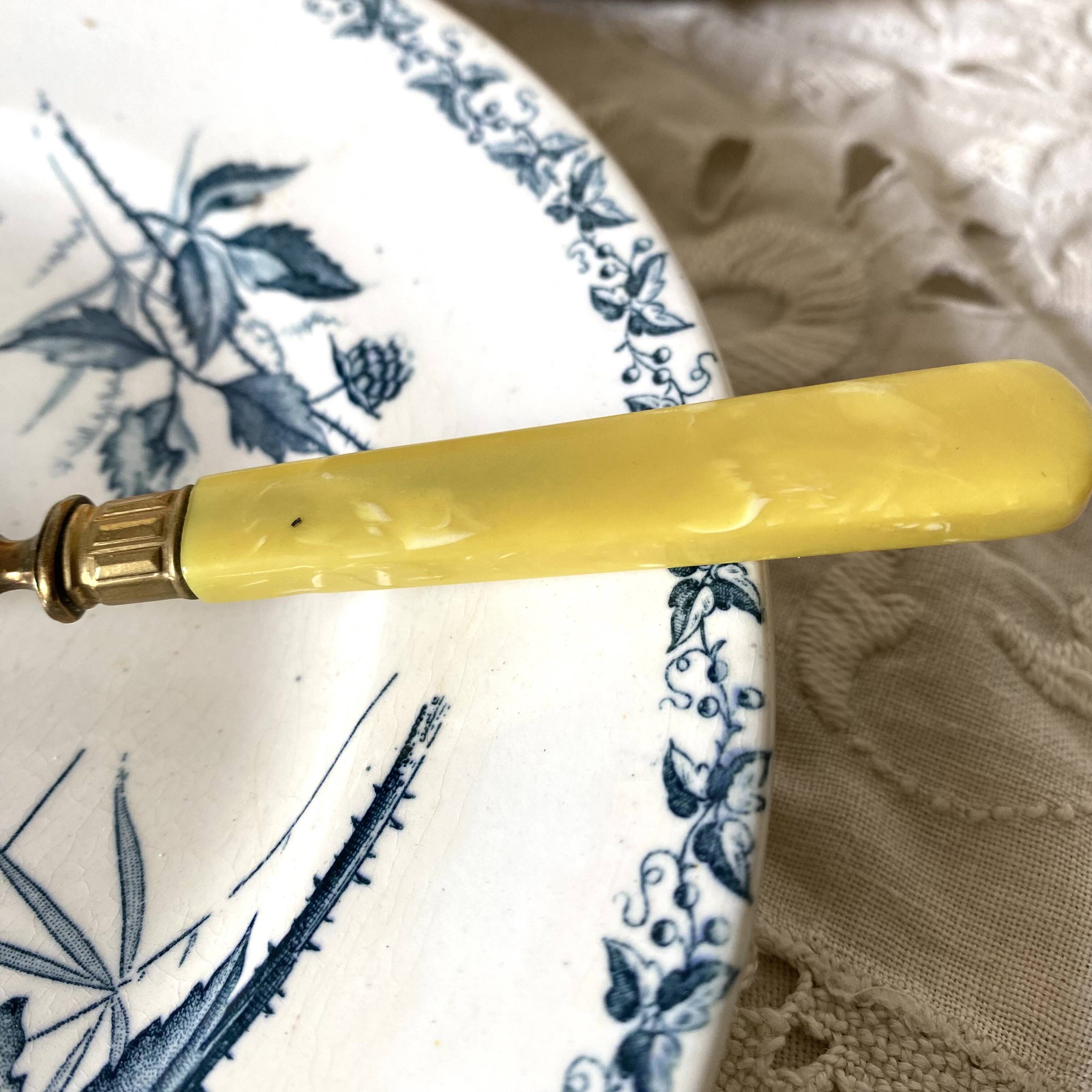 Antique dessert forks in brass and bakelite