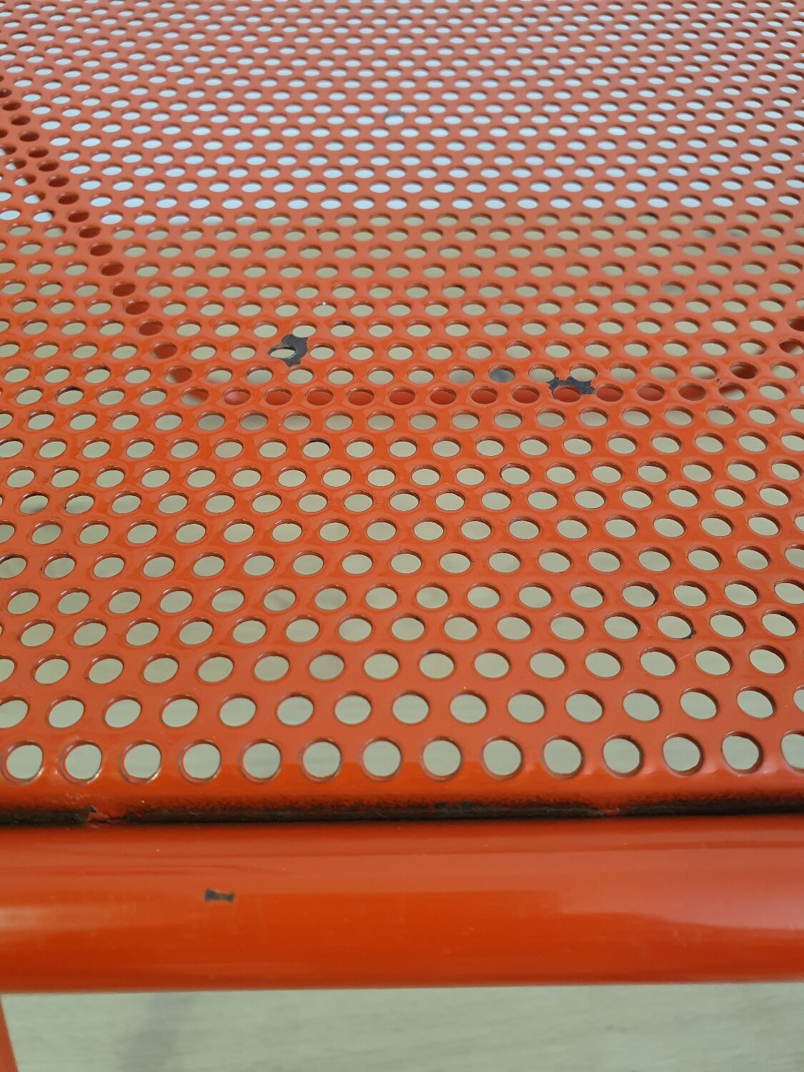 Perforated metal folding chair