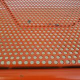 Perforated metal folding chair