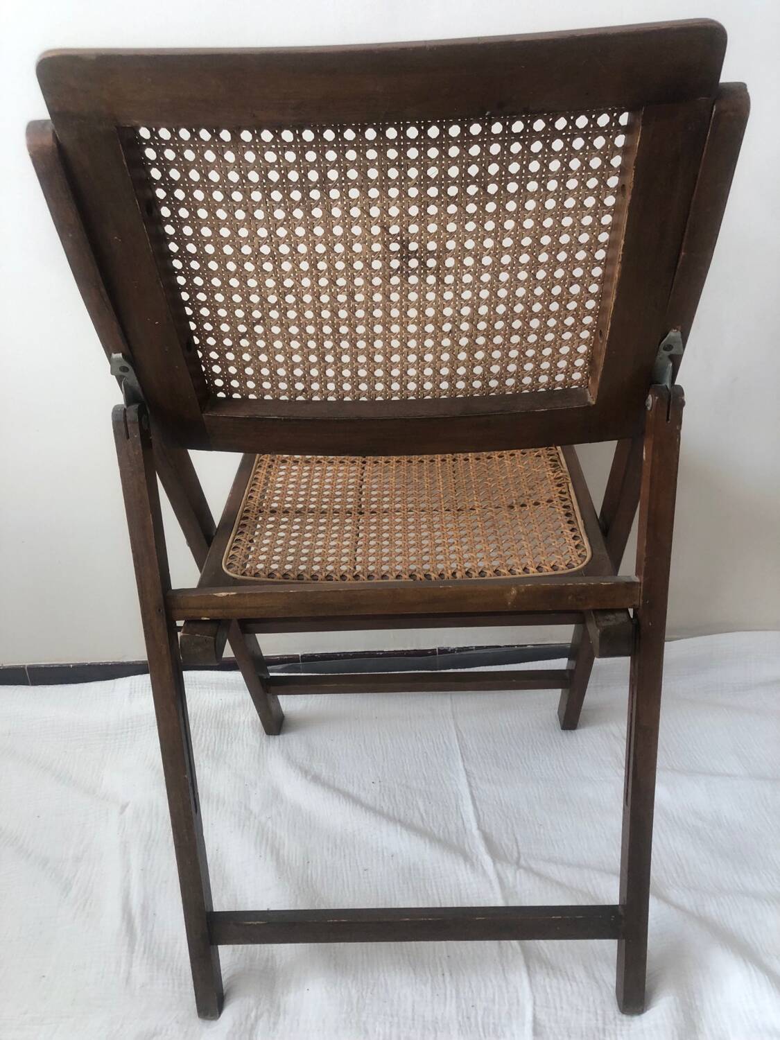 Pair of folding chairs in cane and dark wood