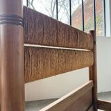 Brutalist style bed with chain and straw