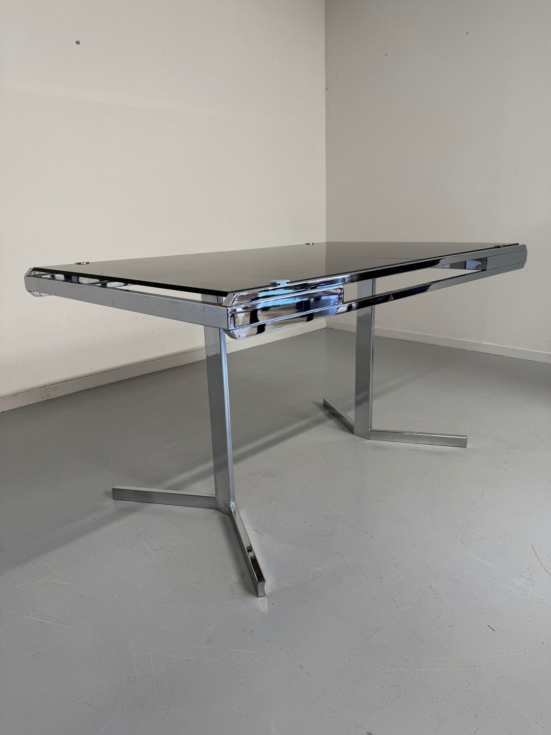 Smoked glass dining table with chrome legs, 1970s design by Roche Bobois.