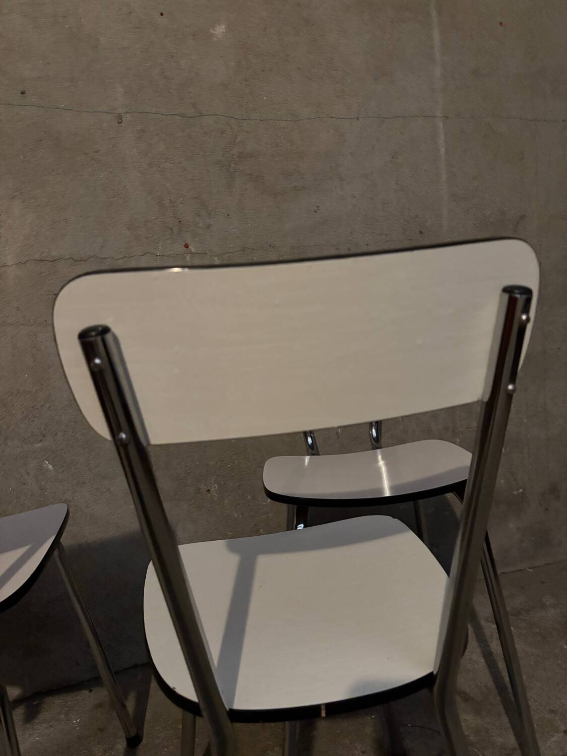 3 white Formica chairs