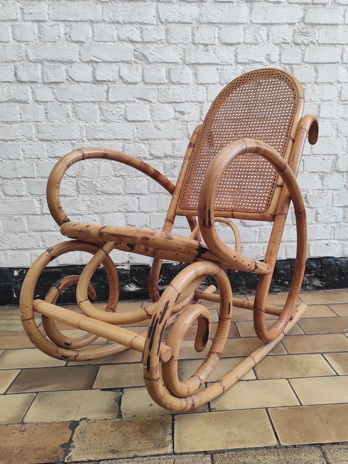Vintage rocking chair in rattan and cane.