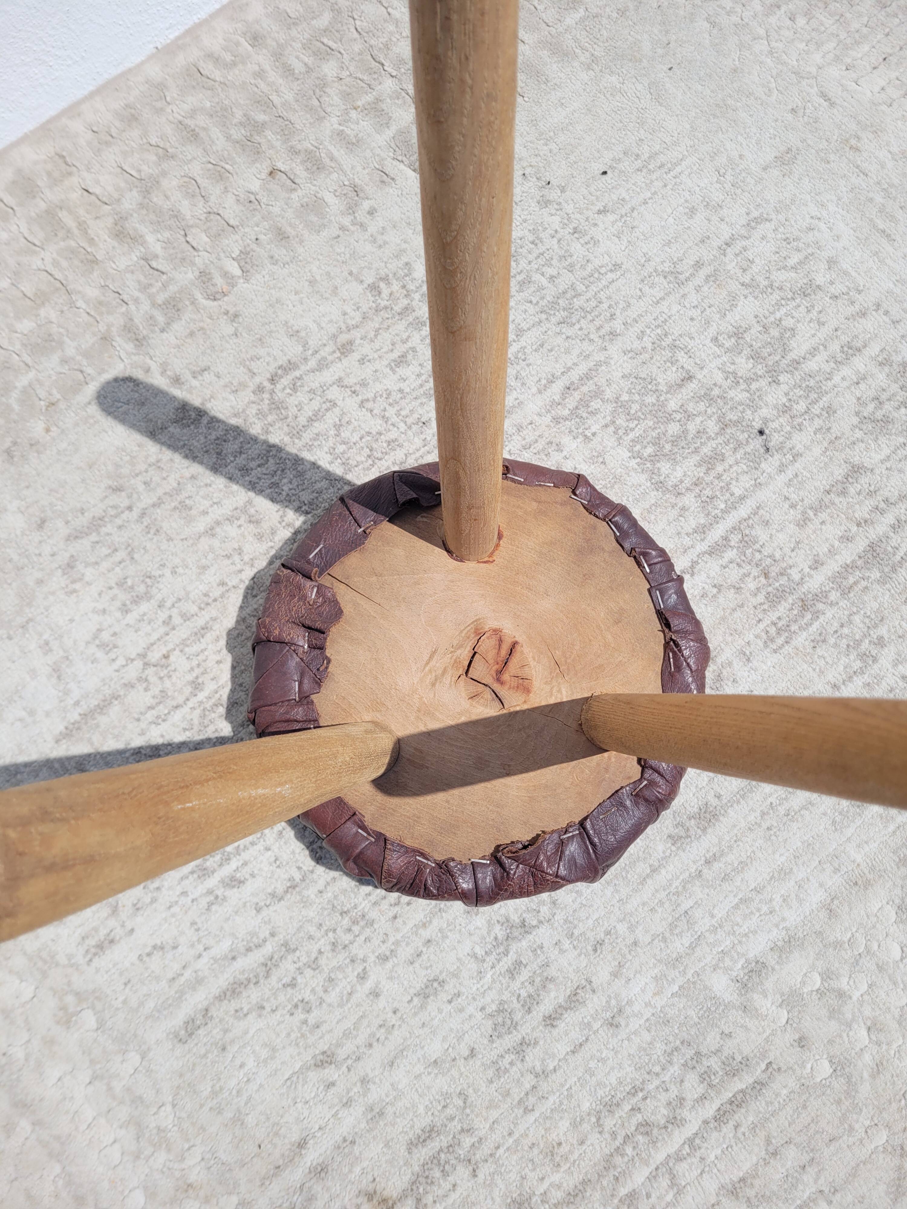 Leather-upholstered tripod stool