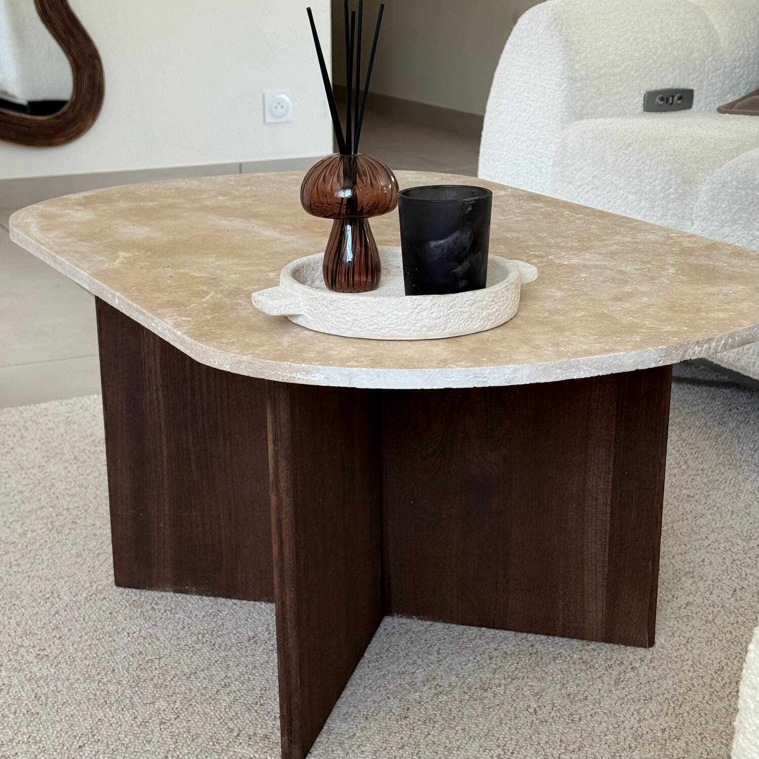 Oval coffee table in travertine and dark oak.