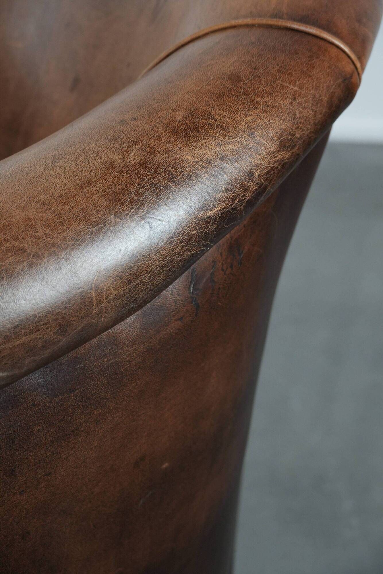Club chair made of sheepskin leather finished with decorative nails