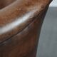 Club chair made of sheepskin leather finished with decorative nails