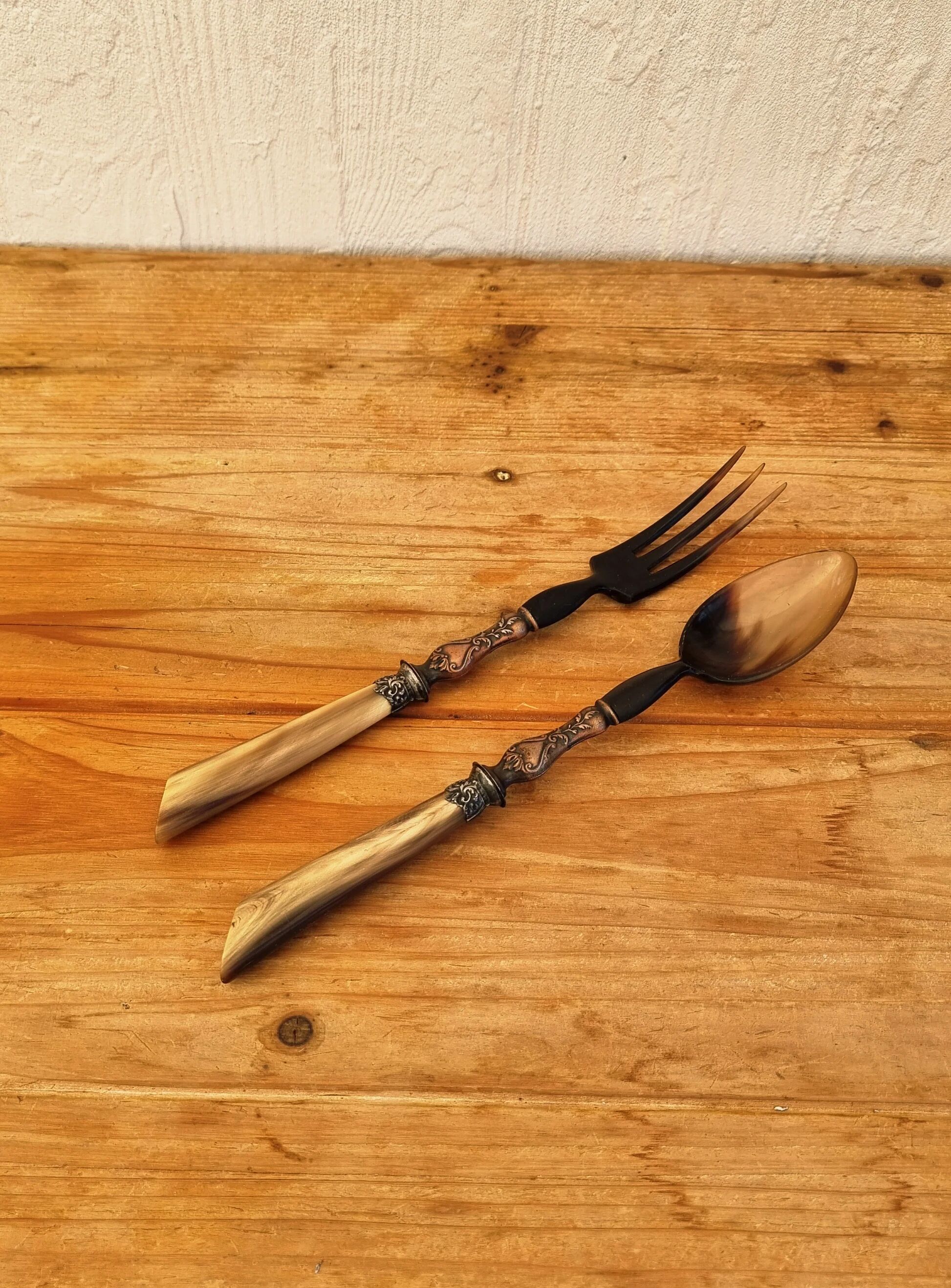 Vintage serving cutlery in horn and wrought metal